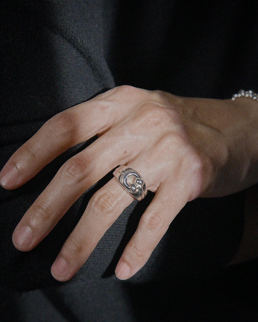 POEMIC Lucid Ring close-up on hand. Architectural design for never-take-off wear.