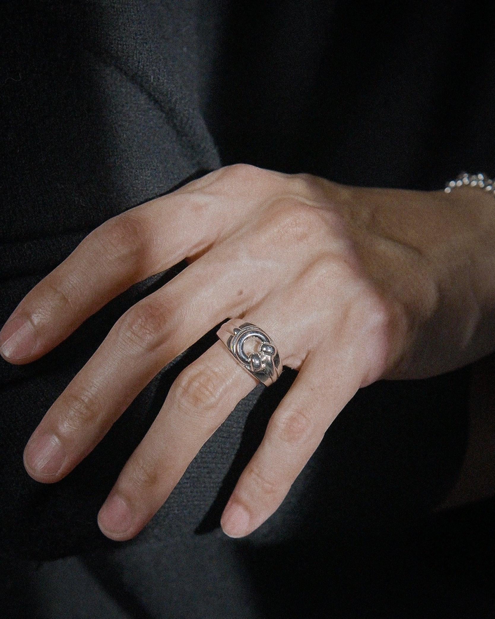 POEMIC Lucid Ring close-up on hand. Architectural design for never-take-off wear.