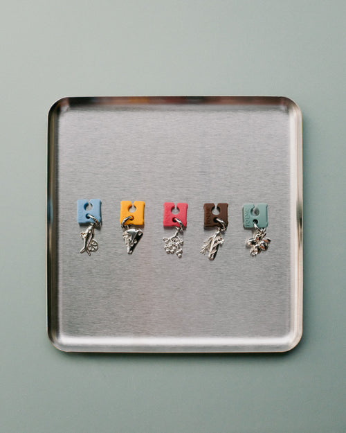 Pendants clipped to wine glasses